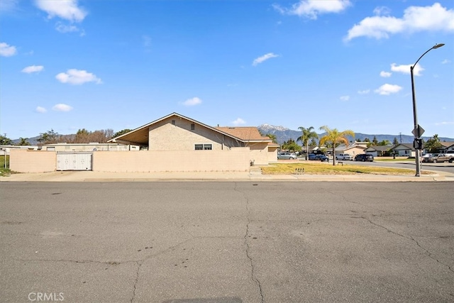 view of front of property featuring fence and a residential view