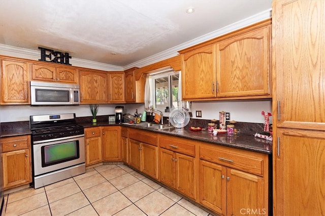 kitchen featuring dark countertops, crown molding, and stainless steel appliances