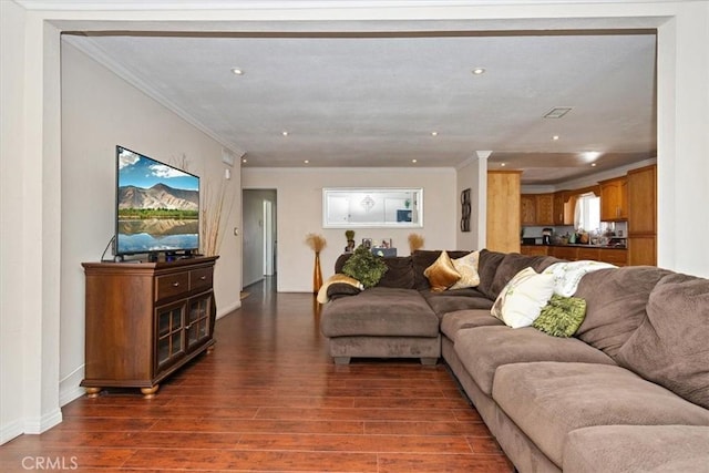 living area with recessed lighting, dark wood finished floors, and ornamental molding