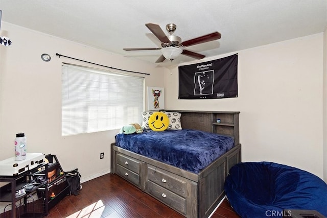 bedroom with a ceiling fan, baseboards, and wood-type flooring