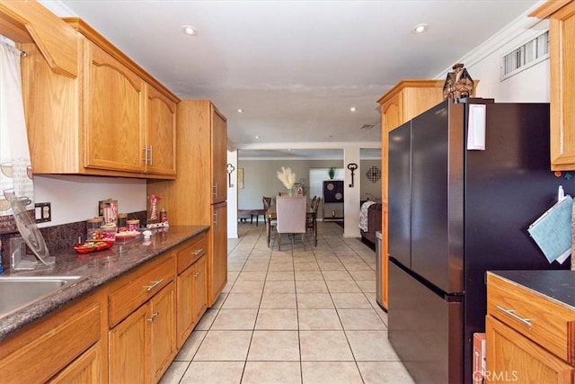 kitchen featuring light tile patterned floors, crown molding, recessed lighting, and freestanding refrigerator