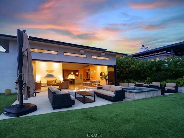 view of patio with an outdoor living space with a fireplace