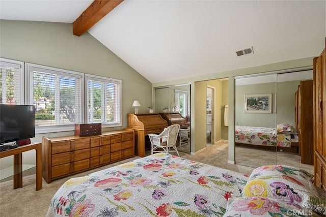 bedroom with baseboards, visible vents, vaulted ceiling with beams, multiple closets, and light carpet