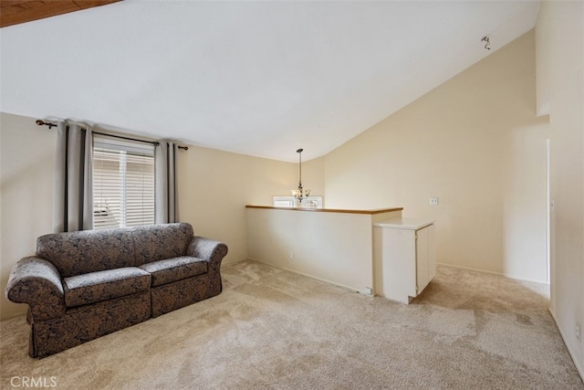 sitting room featuring light carpet, a notable chandelier, and vaulted ceiling