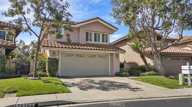 mediterranean / spanish-style house with a tile roof, stucco siding, concrete driveway, and a front yard