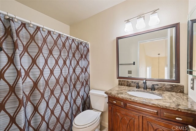 bathroom with toilet and vanity