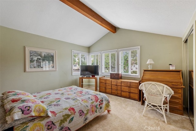 bedroom featuring a textured ceiling, lofted ceiling with beams, and light carpet