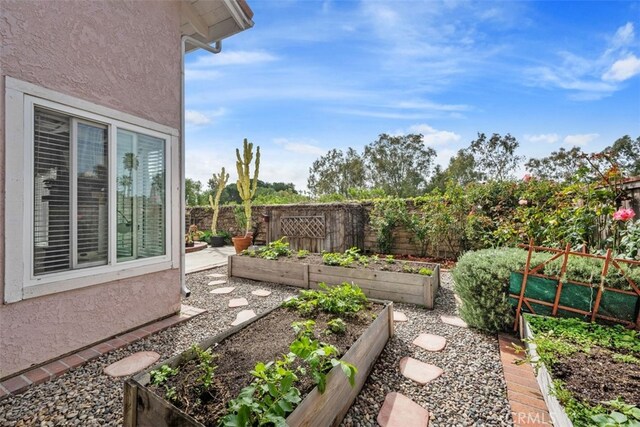 view of yard with a garden and fence