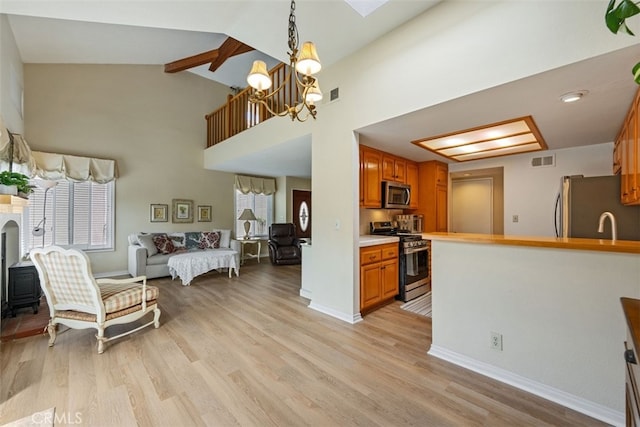 kitchen with visible vents, light wood-type flooring, appliances with stainless steel finishes, a notable chandelier, and open floor plan