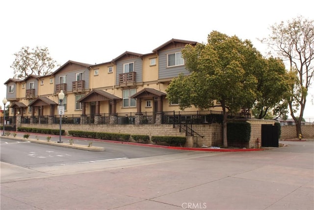 view of front of house featuring a residential view and fence