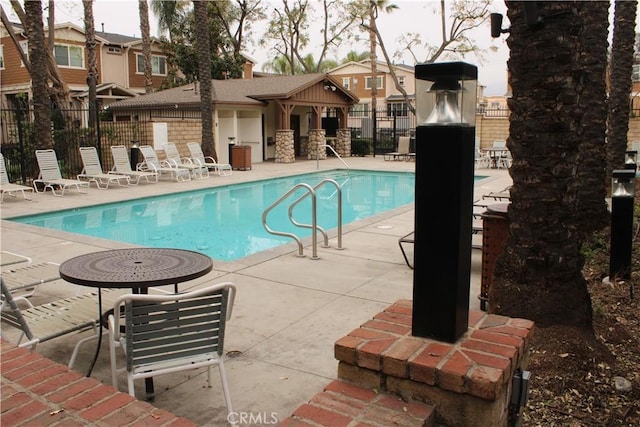 pool featuring a patio and fence