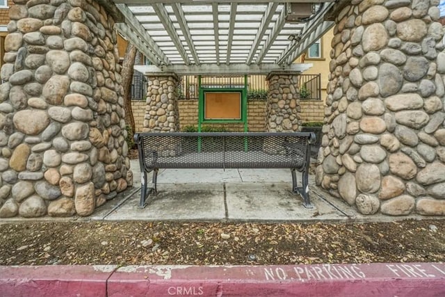 view of exterior entry with a pergola