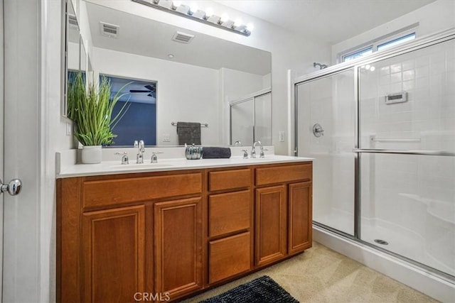 full bathroom with a stall shower, visible vents, and a sink