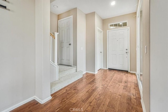 entrance foyer featuring recessed lighting, stairway, baseboards, and wood finished floors