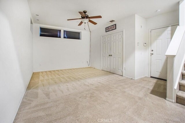 unfurnished bedroom with a closet, visible vents, a ceiling fan, and carpet