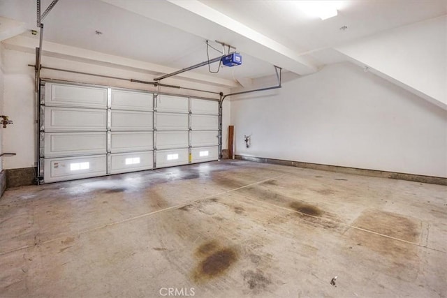 garage featuring a garage door opener and baseboards