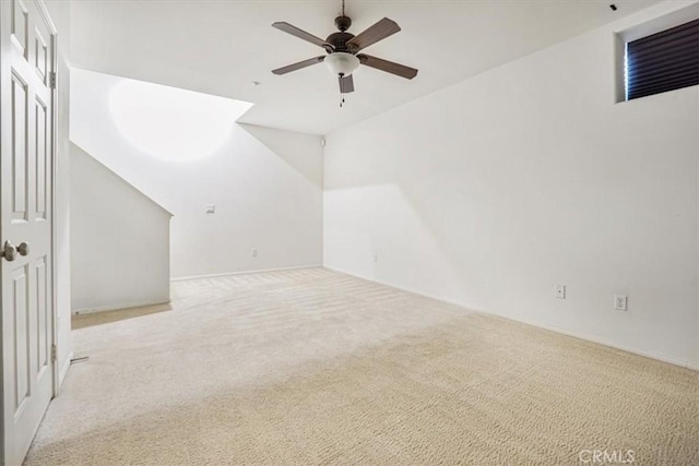 bonus room with a ceiling fan and carpet flooring