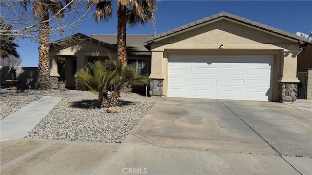 single story home with stucco siding, stone siding, a garage, and driveway