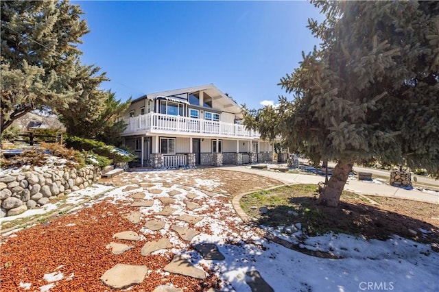 back of property featuring a balcony