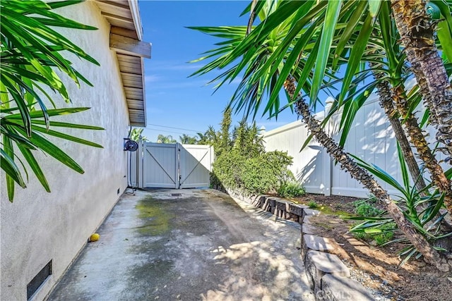 view of patio / terrace featuring fence and a gate