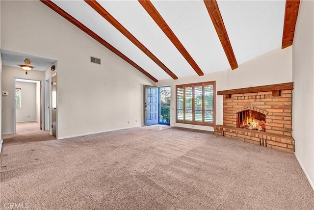 unfurnished living room featuring visible vents, beam ceiling, carpet, and a fireplace