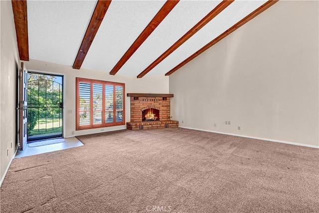 unfurnished living room featuring baseboards, high vaulted ceiling, beam ceiling, a fireplace, and carpet flooring