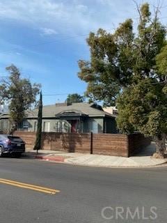 single story home featuring fence