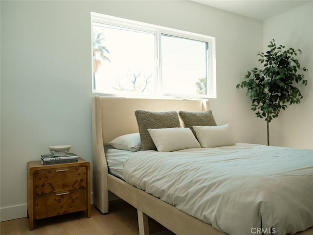 bedroom with light wood finished floors