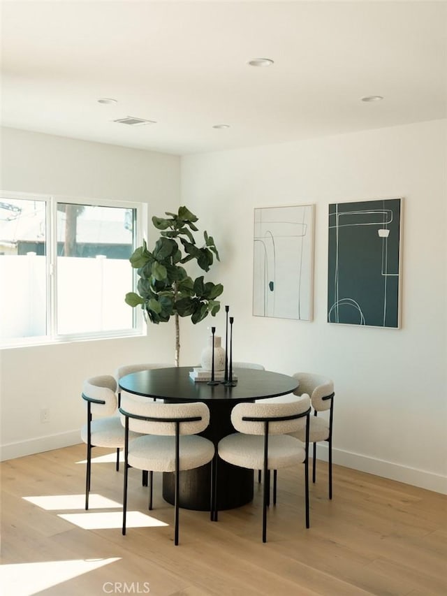 dining space with recessed lighting, visible vents, baseboards, and light wood finished floors