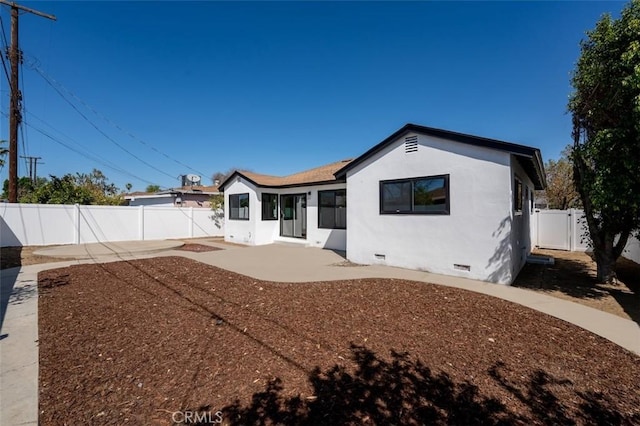 back of property featuring crawl space, a patio area, a fenced backyard, and stucco siding