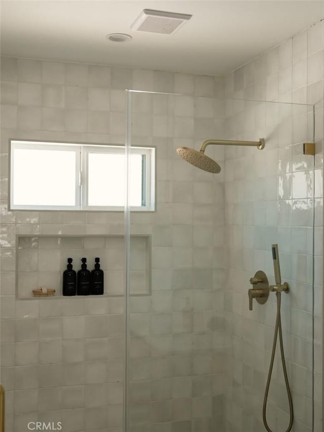 full bathroom featuring visible vents, a shower stall, and a healthy amount of sunlight