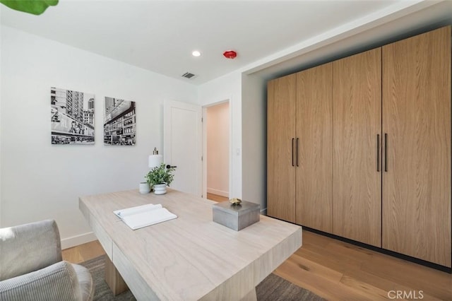 office with recessed lighting, light wood-style floors, visible vents, and baseboards