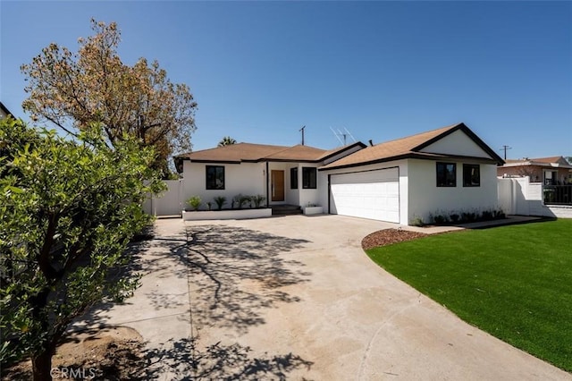 ranch-style home featuring a front yard, fence, driveway, an attached garage, and stucco siding