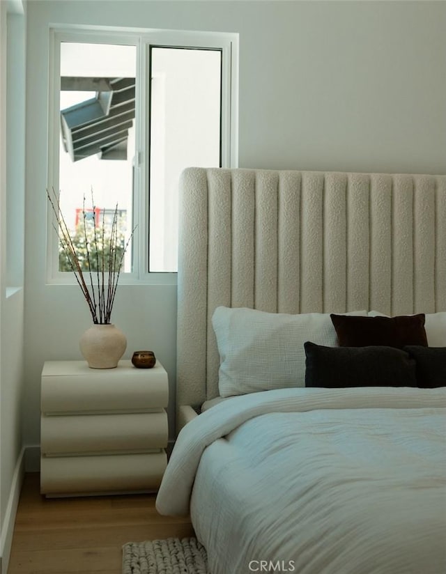 bedroom with wood finished floors