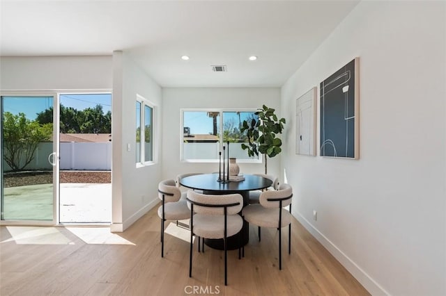 dining area with light wood-type flooring, visible vents, baseboards, and recessed lighting