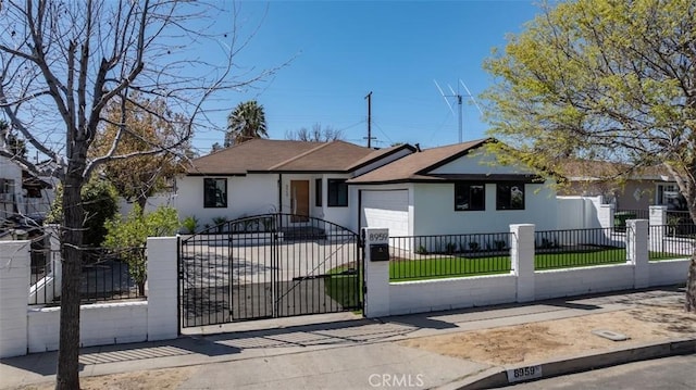 ranch-style house with a fenced front yard, a garage, driveway, and stucco siding