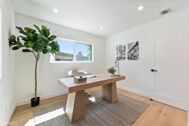 office area with recessed lighting, visible vents, light wood-style flooring, and baseboards