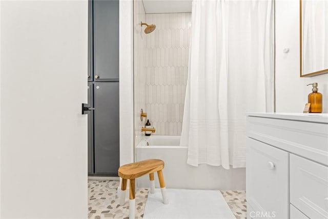 bathroom featuring shower / bath combo with shower curtain and vanity