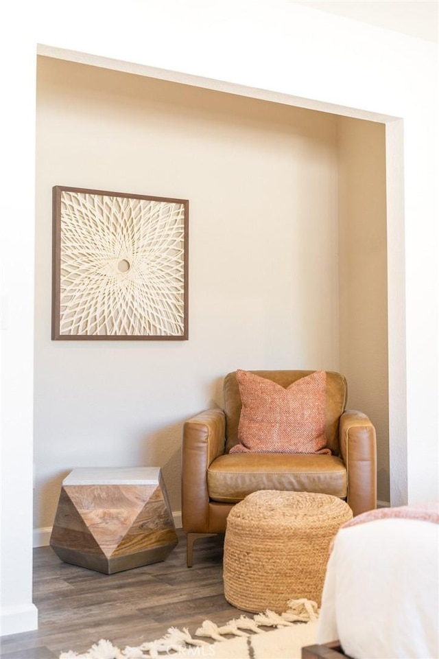 living area with baseboards and wood finished floors