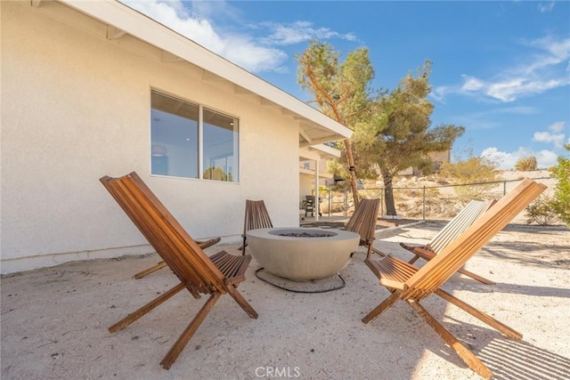 view of patio / terrace featuring fence and an outdoor fire pit