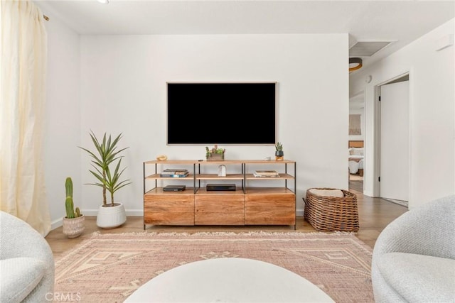 living room with baseboards and wood finished floors