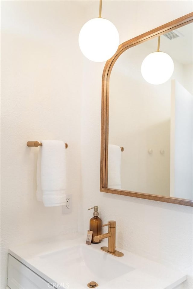 bathroom featuring visible vents and vanity