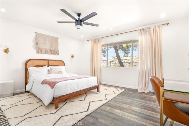 bedroom featuring recessed lighting, a ceiling fan, baseboards, and wood finished floors