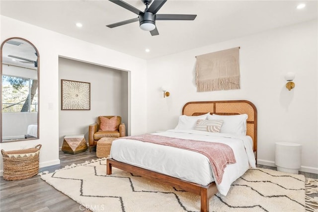 bedroom with a ceiling fan, recessed lighting, wood finished floors, and baseboards