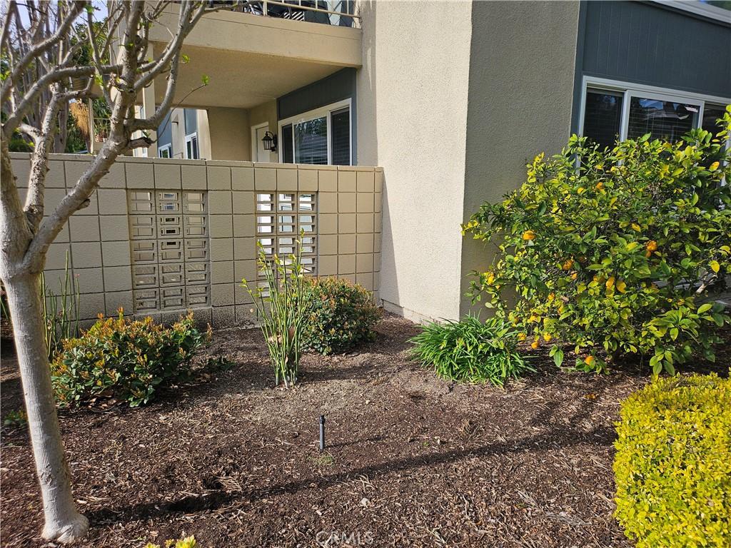 exterior space with mail area and stucco siding