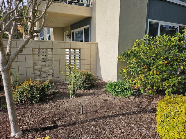 exterior space with mail area and stucco siding