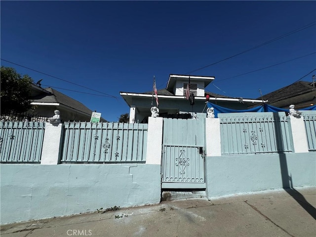 view of gate with a fenced front yard