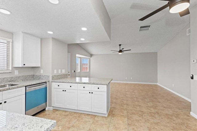 kitchen featuring baseboards, ceiling fan, dishwasher, a peninsula, and white cabinetry