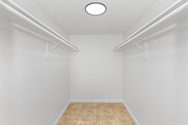 spacious closet featuring light tile patterned flooring