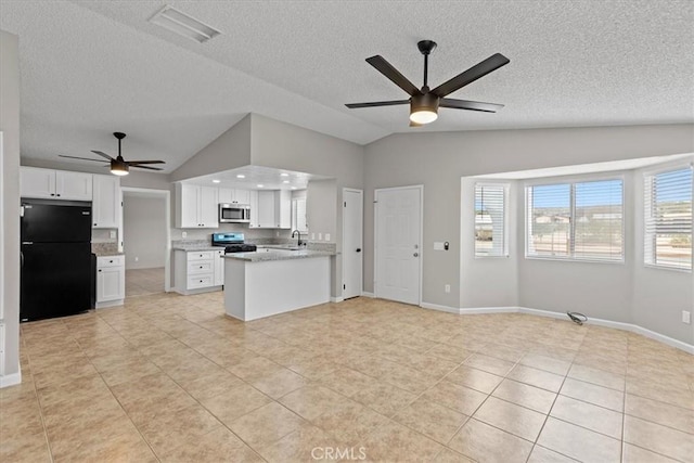 kitchen with visible vents, stainless steel appliances, vaulted ceiling, white cabinetry, and open floor plan